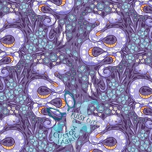 May include: A purple fabric pattern featuring repeating two-headed snakes with white moon and sun symbols on their heads, interspersed with small blue flowers and dark purple foliage. A watermark reads FUSSY CUTS CUSTOM FABRIC.