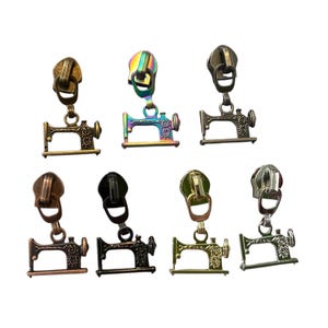 May include: A collection of zipper pulls in various metallic finishes, each featuring a miniature sewing machine charm. Colors include bronze, iridescent, and silver. These decorative zipper pulls are ideal for adding a unique touch to bags, clothing, and craft projects.