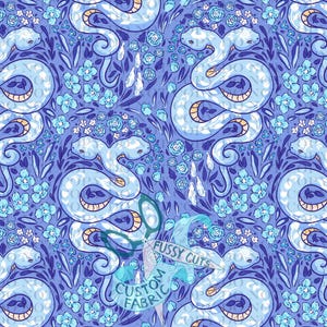 May include: A repeating pattern on fabric featuring light blue two-headed snakes intertwined with small blue flowers and dark blue leaves on a medium blue background. A logo with scissors and the text FUSSY CUTS CUSTOM FABRIC is visible.