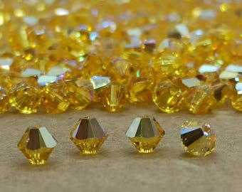 Perlas bicono de cristal Swarovski Light Topaz AB (5 mm)