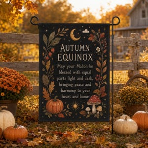 May include: A black garden flag featuring the text Autumn Equinox and May your Mabon be blessed with equal parts light and dark, bringing peace and harmony to your heart and home, decorated with a crescent moon, pumpkin, and mushrooms.