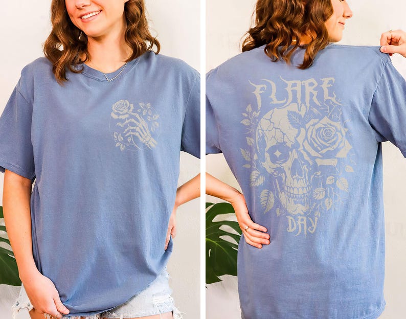 May include: A light blue t-shirt with a white skull and rose graphic on the back. The text "FLARE DAY" is printed below the graphic.