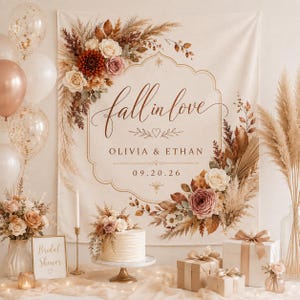 May include: A fabric backdrop featuring the text fall in love, OLIVIA & ETHAN, and 09.20.26, decorated with dried pampas grass and flowers in shades of cream, brown, and dusty rose, displayed with a cake, gifts, and balloons.