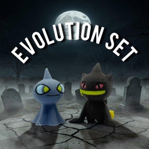 May include: A spooky scene featuring two 3D-printed figures, one blue and one black, with the text "EVOLUTION SET" above. The figures are set in a graveyard under a full moon, creating a Halloween or fantasy theme.