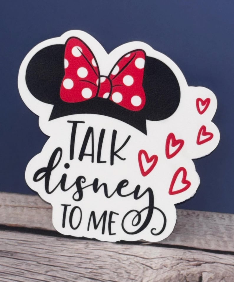 May include: White sticker with a black and red Minnie Mouse head, a red bow with white polka dots, and the text "TALK disney TO ME" in black cursive lettering. There are four red hearts around the text.