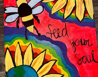 May include: A painting of two sunflowers with a globe in the centre of each. The sunflowers are surrounded by a rainbow. The background is red. The text "feed your soul" is written in black cursive.