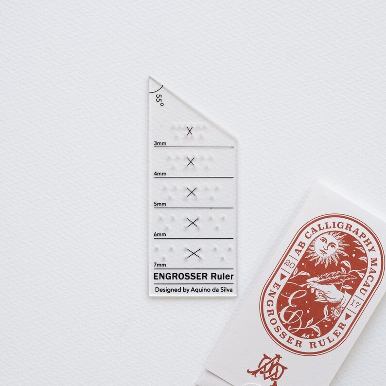 The Engrosser calligraphy ruler on paper with it's beautiful packaging