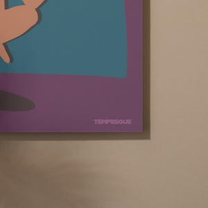 May include: A close-up of a framed art print with a minimalist design. The artwork features a teal and peach abstract shape against a purple background. The word "TEMPESQUE" is printed in light purple at the bottom.