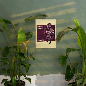 May include: A poster with the words "DON'T SPIRAL EVOLVE" and an illustration of a figure with a striped pattern. The figure is standing on a dark purple background. The poster is hanging on a green wall, with green plants in the foreground.