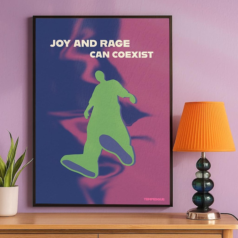 llustration of a stylized human figure in green moving across a blurred blue and pink background, with the phrase “Joy and Rage Can Coexist” in bold lettering. A modern emotional wall art poster exploring personal growth, boundaries, mental health, and emotional complexity.