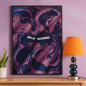Abstract poster with flowing navy and mauve shapes and the phrase “Do It Scared” centered in soft white text. The artwork represents courage, emotional growth, and facing fear through abstract movement and color.