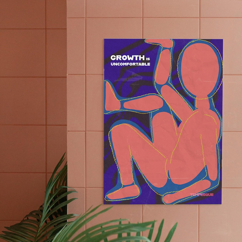 May include: A poster with the text "GROWTH IS UNCOMFORTABLE" in white on a dark blue background. The poster features a stylized, abstract figure in shades of coral and blue with yellow outlines. The poster is hanging on a pink tiled wall.