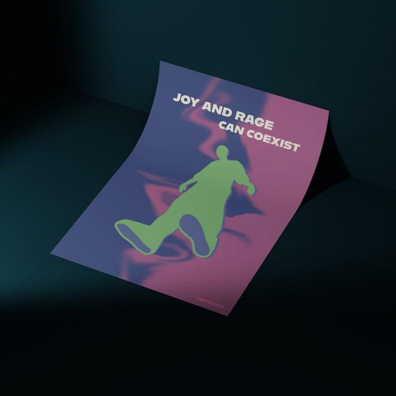 May include: A poster with the text "JOY AND RAGE CAN COEXIST" in white. The poster features a green silhouette of a person against a background of swirling purple and pink colors. The poster is slightly curled.