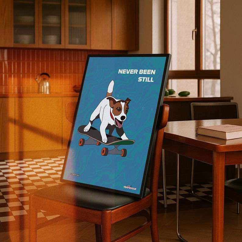 May include: A framed art print featuring a cartoon dog skateboarding. The dog is white and brown with a red collar, set against a blue background with the words "NEVER BEEN STILL". The skateboard has orange wheels.