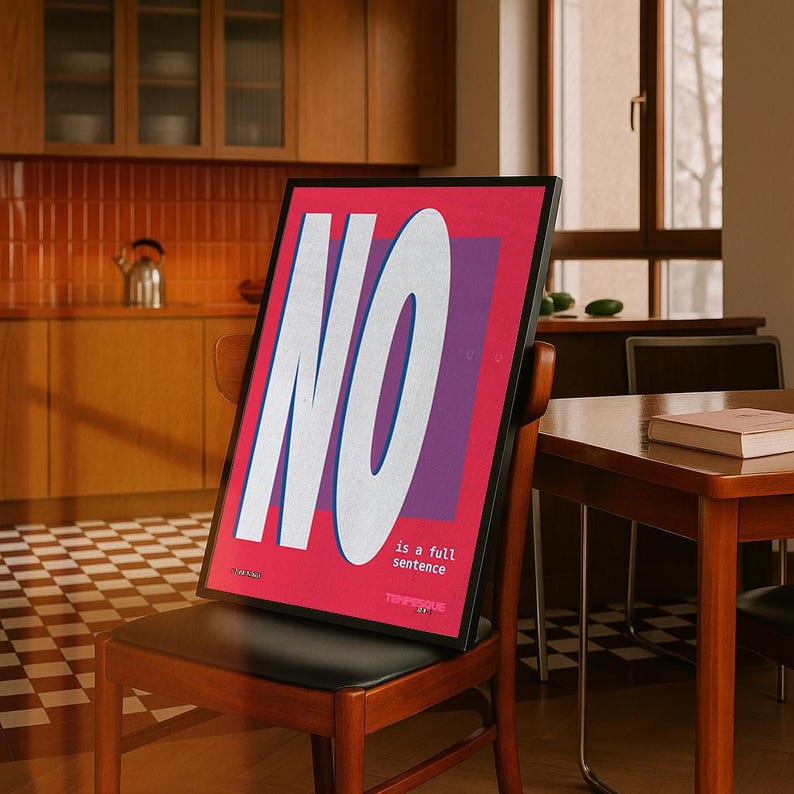 May include: A framed poster with the word "NO" in large white letters on a red background, with a purple rectangle behind the "O". The text "is a full sentence" is below the word "NO". The poster is propped on a wooden chair.