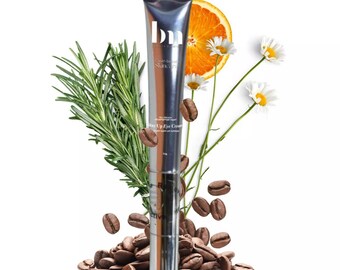 May include: A silver tube of Stay Up Eye Cream by the brand 'Skin by Sana'. The tube is surrounded by coffee beans, rosemary sprigs, chamomile flowers, and an orange slice.