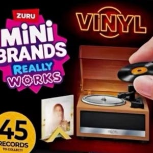 May include: A miniature brown record player with a silver platter and black tonearm, accompanied by a small square album cover on a yellow stand. The packaging features the text Zuru Mini Brands Really Works, Vinyl, and 45 Records to Collect.