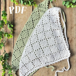 May include: Two triangular crochet bandanas, one in sage green and one in white, featuring an intricate openwork diamond pattern with delicate lace edges and long tie strings. The text PDF is visible in the upper left corner of the image.