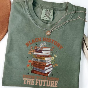 Black History Book Lovers Shirt lovers, this Comfort Colors tee is made for turning pages and honoring legacies, all in one easy, everyday look. This shirt  is not just a garment; it's a celebration of past triumphs and future aspirations.