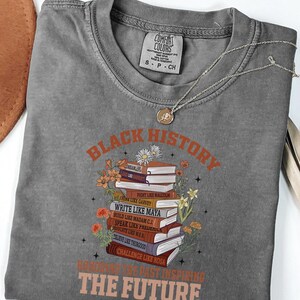 Black History Book Lovers Shirt lovers, this Comfort Colors tee is made for turning pages and honoring legacies, all in one easy, everyday look. This shirt  is not just a garment; it's a celebration of past triumphs and future aspirations.