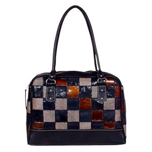 May include: A rectangular handbag featuring a chequered pattern of dark blue, brown, and speckled grey squares. The bag has two thin shoulder straps, a top zip closure, and a solid dark blue base with white stitching along the bottom edge.