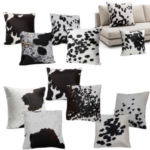 May include: A collection of square throw pillows featuring various black and white cowhide patterns. Each pillow displays a unique arrangement of dark spots and patches against a white background, showcasing different densities of animal print designs.