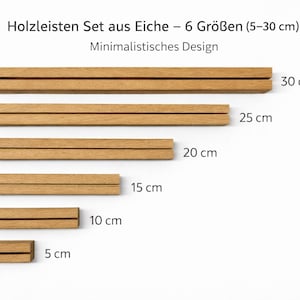 May include: A set of six oak display rails, sizes ranging from 5 cm to 30 cm. The rails have a minimalist design and are displayed on a white background. The text "Holzleisten Set aus Eiche - 6 Gr&ouml;&szlig;en (5-30 cm)" is visible.