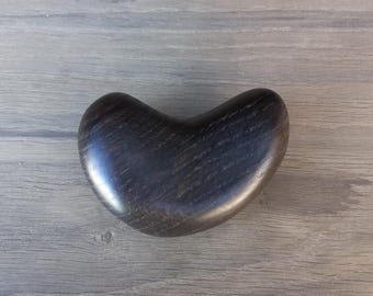 May include: A dark wood heart-shaped trinket box with a smooth, polished finish.