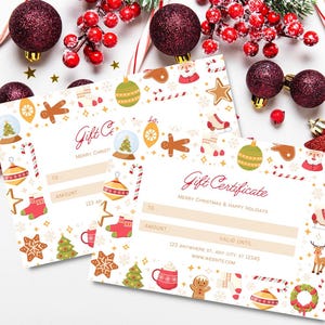 May include: Two Christmas-themed gift certificates with festive illustrations of ornaments, gingerbread men, and snow globes. The certificates have space for recipient, amount, and a website address. Decorations include red berries, ornaments, and candy canes.