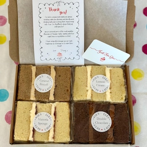May include: A cardboard box containing four individually wrapped cake slices labeled Caramel Biscoff, Lemon Cream, Victoria Sponge, and Double Chocolate. A thank you note and a Just For You card are included inside the box with the cake slices.