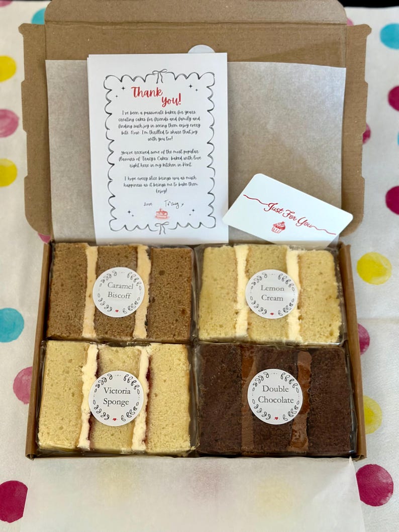 May include: A cardboard box containing four individually wrapped cake slices labeled Caramel Biscoff, Lemon Cream, Victoria Sponge, and Double Chocolate. A thank you note and a Just For You card are included inside the box with the cake slices.