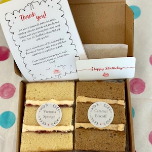 May include: A cardboard box containing two rectangular cake slices, one labeled Victoria Sponge and the other Caramel Biscoff. A thank you note and a Happy Birthday card are included. The note reads: Thank you! I've been a passionate baker.