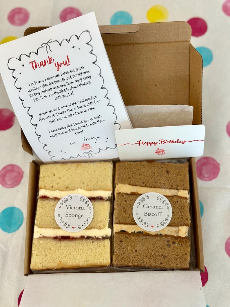 May include: A cardboard box containing two rectangular cake slices, one labeled Victoria Sponge and the other Caramel Biscoff. A thank you note and a Happy Birthday card are included. The note reads: Thank you! I've been a passionate baker.