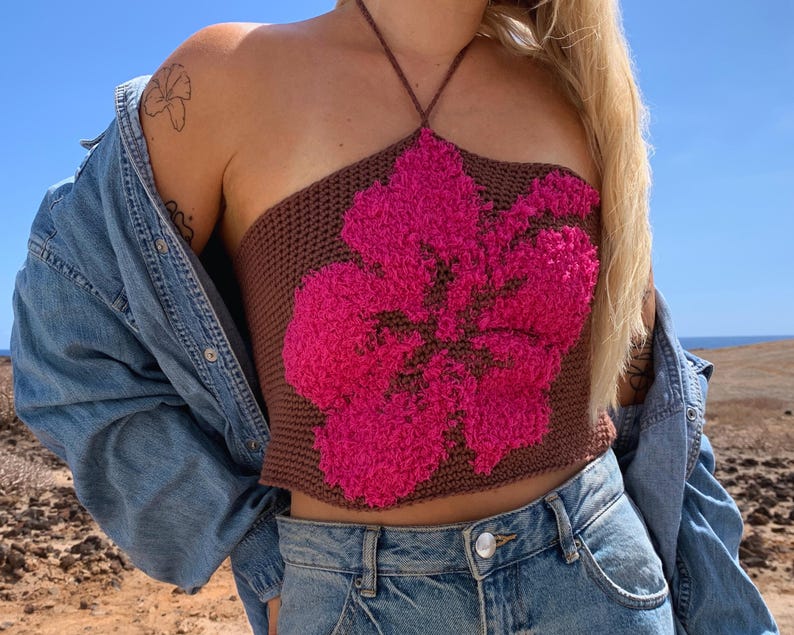 Skapa din egen vackra hibiskus-topp med detta nybörjarvänliga virkmönster! Detta mönster inkluderar detaljerade instruktioner för att virka en topp med ett vackert hibiskusblommotiv. Perfekt för dig som älskar att virka och vill skapa något unikt och personligt. Oavsett om du är nybörjare eller har erfarenhet, kommer du att kunna följa mönstret enkelt och få en fantastisk resultat.