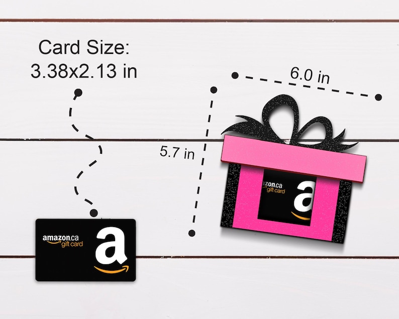 May include: A pink gift box with a black bow and a black and white Amazon gift card inside. The gift box is 6 inches wide and 5.7 inches tall. The gift card is 3.38 inches wide and 2.13 inches tall.