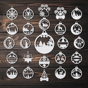 May include: A set of 25 white wooden Christmas ornament cutouts with various designs, including snowflakes, reindeer, a snowman, a house, a Christmas tree, and the word "Believe".