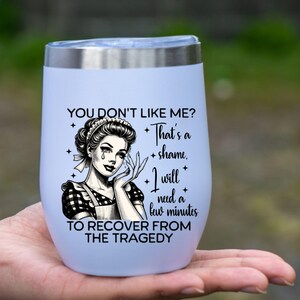May include: White stainless steel tumbler with a black and white illustration of a woman in a maid's outfit and the text "You don't like me? That's a shame. I will need a few minutes to recover from the tragedy."
