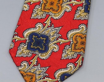 May include: A red tie with a repeating pattern of gold, navy blue, and orange floral designs. The tie has a textured surface and a classic shape, suitable for formal or business attire.