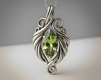 May include: A silver pendant necklace featuring a marquise-cut green gemstone set in a polished metal frame with swirling, organic scrollwork details. The pendant hangs from a delicate silver chain, showcasing a symmetrical design with four prongs.