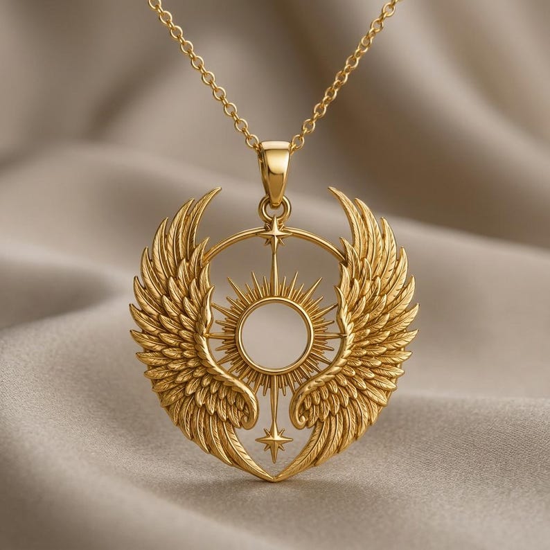A beautifully detailed rose gold Seraph Wing Halo Pendant, featuring two large, intricately feathered angelic wings symmetrically framing a central circular halo with radiating sun rays. A small star is positioned above the halo, and another below, connecting the wings at the bottom. The pendant hangs from a delicate rose gold cable chain, resting on a smooth, light beige background with subtle shadows, highlighting the pendant's polished finish and three-dimensional texture.