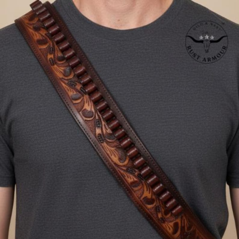 May include: A brown leather cartridge belt with floral tooling and a row of bullet loops. The belt is worn diagonally across the body. The image also includes a circular logo with the text "Rust Armour".