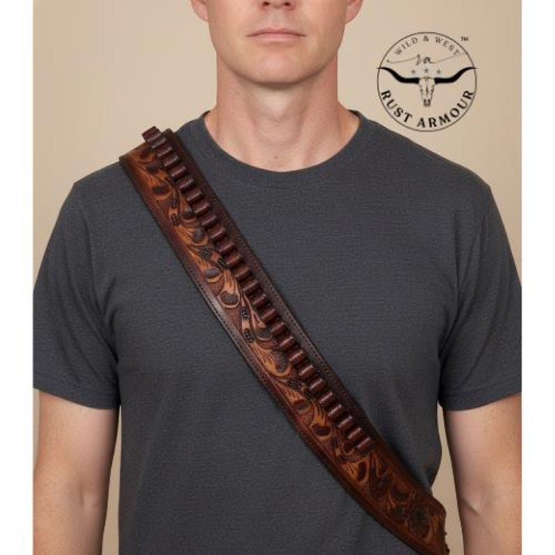 May include: A brown leather cartridge belt with a floral tooled design, worn diagonally across the chest. The belt has multiple cartridge loops and is made of dark brown leather. The image includes the "Rust Armour" logo.