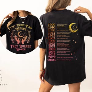 a woman wearing a black t - shirt with an image of a woman's