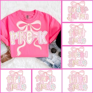 May include: A bright pink t-shirt with the text "Pre-K" in a decorative font, embellished with a bow design. Additional images show grade level designs from Kindergarten to Fifth Grade, all with a similar bow and font style.