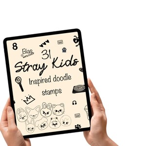 May include: A tablet shows a cream-coloured graphic with the text "Stray Kids Inspired doodle stamps." The design includes cartoon faces, hearts, and other small illustrations in black. The tablet is held by two hands against a white background.