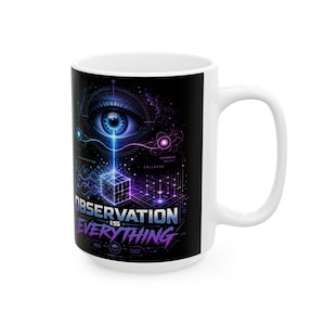 May include: White ceramic mug with a black graphic design. The design features a detailed eye, geometric shapes, and the text "OBSERVATION IS EVERYTHING" in blue and purple hues. The mug has a large handle.