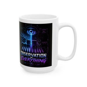 May include: White ceramic mug with a black graphic design. The design features a blue eye, geometric shapes, and the text "OBSERVATION IS EVERYTHING" in blue and purple. The mug has a large handle.