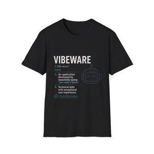 May include: A black short-sleeve t-shirt featuring a white dictionary-style definition graphic for the word VIBEWARE. The print includes a robot icon, phonetic spelling, and two numbered definitions about software development and technical debt.