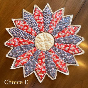May include: A handmade, starburst-shaped quilted trivet. The trivet features alternating red and navy blue floral print fabric segments, with a cream-colored center. The edges are finished with a white, scalloped trim. The text "Choice E" is at the bottom.