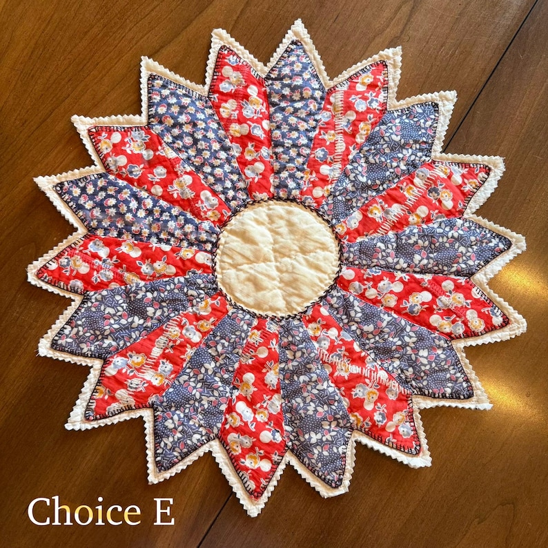 May include: A handmade, starburst-shaped quilted trivet. The trivet features alternating red and navy blue floral print fabric segments, with a cream-colored center. The edges are finished with a white, scalloped trim. The text "Choice E" is at the bottom.